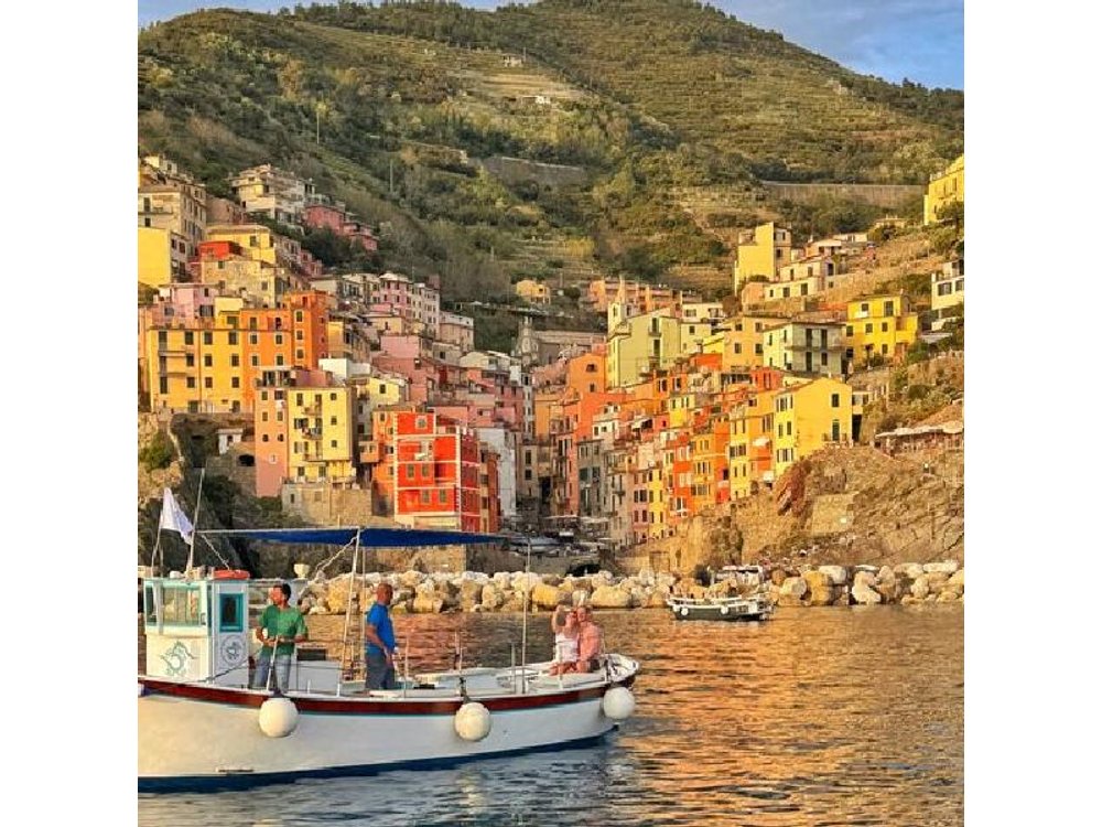 Cinque Terre sunset boat tour with a traditional ligurian gozzo