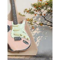 Heavy relic light pink electric guitar inlaid with vibrato bridge striking bar retro tuner chrome hardware