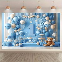 The background banner for the 1st birthday party - a festive blue and white balloon design with a "1" cake and cup pattern