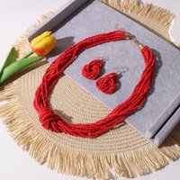 A fashionable commuting multi-layered beaded and knotted necklace and earring set featuring 1 necklace and 1 pair of earrings