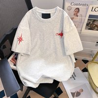 A unique one of a kind men's top featuring an embroidered eight pointed star