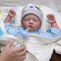 22-Inch Vinyl Reborn Doll | Cartoon Striped Outfit, Closed Eyes, Posable, Realistic Skin & Facial Features, Collectible,
