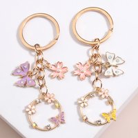 Porte-clés papillon en émail mignon, fleur Sakura, porte-clés de jardin, cadeaux d'amitié pour femmes et filles, bijoux faits à la main