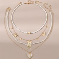 4pcs/set Kids Everyday White Bead Set โ Butterfly & Heart Pendants on Stackable Strands for Effortless, Adorable Style.