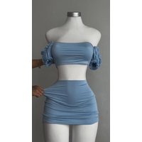 A sexy and fashionable two-piece short skirt with hollowed-out pleated puffed sleeves that wraps the hips