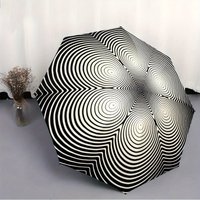 Folding Umbrella The umbrella features a black and white concentric circle optical illusion pattern. Fits Travel, Backpack, Ho