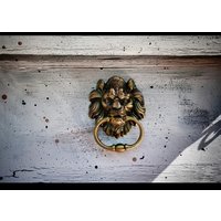 An Antique Bronze Lion's Head Door Knocker - Polished Metal Finish, Touch and Remote Control, Large Hanging Loop Door Handle
