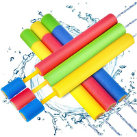 Children pull foam water gun to fight water fights manually, and many people interact on outdoor beach in summer