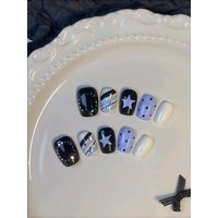 10 Short Square Nails in Black, Light Purple, and Cream White as Main Colors, Decorated with Hand-Painted Stars, Polka Dots, and Five-Pointed Star Glitter. the Overall Design Is Simple and Cool, with