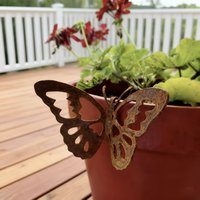 Old hollow wrought iron butterfly decoration, retro tones, outdoor gardening decoration