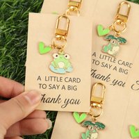 2D 3/6pcsChildlike Cute Frog Thank You Keychain,Q Round-faced frog with different cute poses,The green heart pendant is like a l