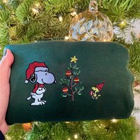 The Embroidered Crewneck Has Snoopy And Woodstock Christmas Sweatshirt