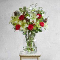 Christmas flower bouquet with red roses and green highlights | Send flowers online | Santa's Sleigh | size: showstopper image