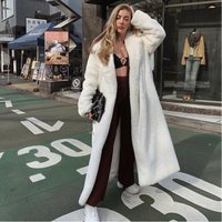 Women street fashion warm faux fur coat with belt.