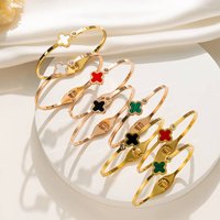 LuckyCharm's Golden Metal Bracelet With Four-Leaf Clover Design, Elegant Jewelry For Women, Fashionable Gift In Gold/Red/Black/Green