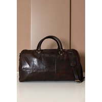 Sac de voyage en cuir marron foncé avec poignée pliante