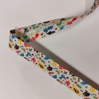 Biais replié fantaisie monstres écru 25mm - Mondial Tissus