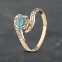 Pre-Owned 14ct Yellow Gold Blue Topaz and 0.10ct Diamond Twist Ring 41671502
