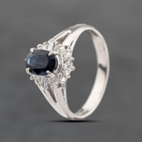 Pre-Owned Platinum 0.68ct Sapphire and 0.19ct Diamond Oval Cluster Ring 43361147