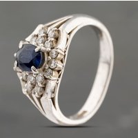 Pre-Owned Platinum 0.88ct Sapphire and 0.33ct Brilliant Cut Diamond Oval Cluster Ring 43361173