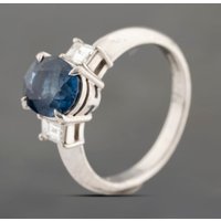 Pre-Owned Platinum 2.41ct Sapphire and 0.38ct Step Cut Diamond Three Stone Ring 43361182