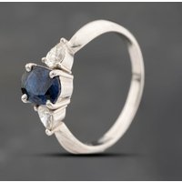 Pre-Owned Platinum 1.29ct Sapphire and 0.35ct Pear Cut Diamond Oval Three Stone Ring 43361207