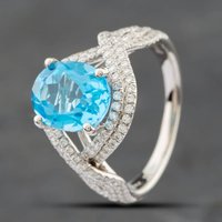 Pre-Owned 14ct White Gold Oval Cut Blue Topaz and Single Cut Diamond Crossover Ring 43451006