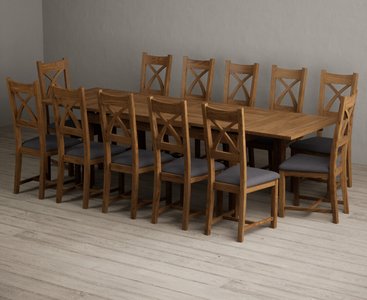Photo of extending buxton 180cm rustic solid oak dining table with 12 charcoal grey rustic solid oak chairs