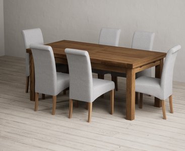 Photo of extending buxton 180cm rustic solid oak dining table with 6 grey scroll back chairs