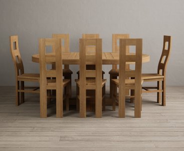 Photo of extending helmsley solid oak pedestal dining table with 8 oak natural chairs