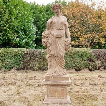 Statue - hand carved stone lady - with grapes