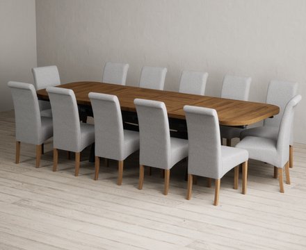 Extending olympia 180cm oak and dark blue dining table with 12 grey scroll back chairs
