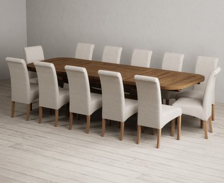 Extending olympia 180cm rustic solid oak dining table with 12 natural scroll back chairs