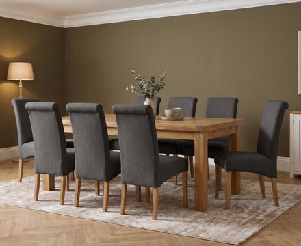 Extending buxton 140cm solid oak dining table with 8 charcoal grey scroll back chairs