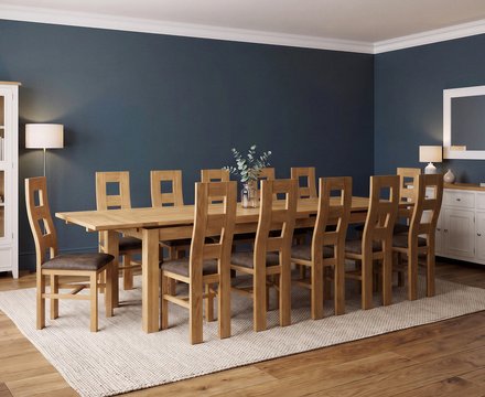 Extending buxton 180cm solid oak dining table with 12 brown natural chairs