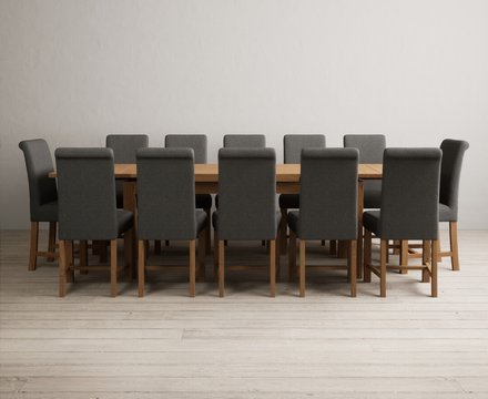 Extending buxton 180cm solid oak dining table with 12 charcoal grey braced chairs