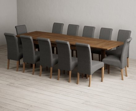 Extending buxton 180cm rustic solid oak dining table with 12 charcoal grey scroll back chairs