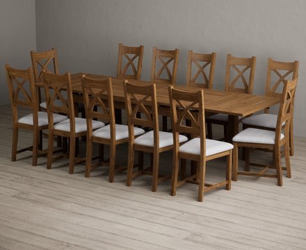 Extending buxton 180cm rustic solid oak dining table with 12 light grey rustic solid oak chairs