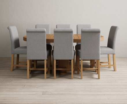 Extending helmsley solid oak pedestal dining table with 8 grey braced chairs