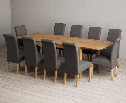 Extending thetford 150cm solid oak dining table with 10 charcoal grey scroll back chairs