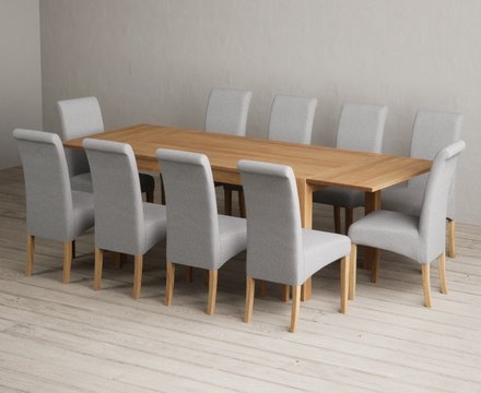 Extending thetford 150cm solid oak dining table with 10 grey scroll back chairs
