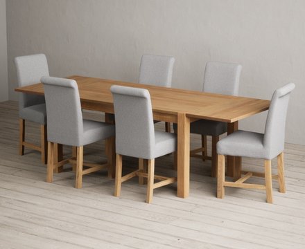 Extending thetford 150cm solid oak dining table with 6 grey braced chairs