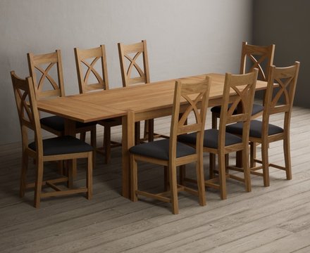 Extending thetford 150cm solid oak dining table with 8 charcoal grey natural solid oak chairs