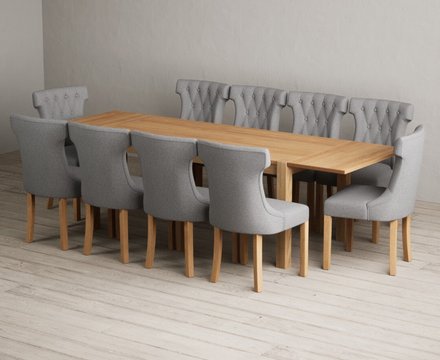 Extending thetford 180cm solid oak dining table with 10 grey clara chairs