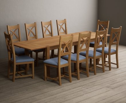 Extending thetford 180cm solid oak dining table with 10 blue natural solid oak chairs