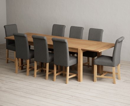 Extending thetford 180cm solid oak dining table with 8 charcoal grey braced chairs
