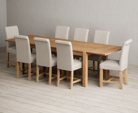 Extending thetford 180cm solid oak dining table with 8 natural braced chairs