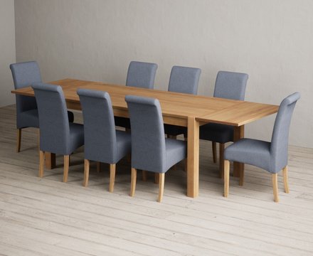 Extending thetford 180cm solid oak dining table with 8 blue scroll back chairs