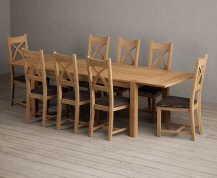 Extending thetford 180cm solid oak dining table with 8 brown natural solid oak chairs