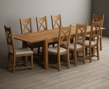 Extending thetford 180cm solid oak dining table with 8 linen natural solid oak chairs